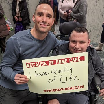 Woman holding We Can Do It! sign